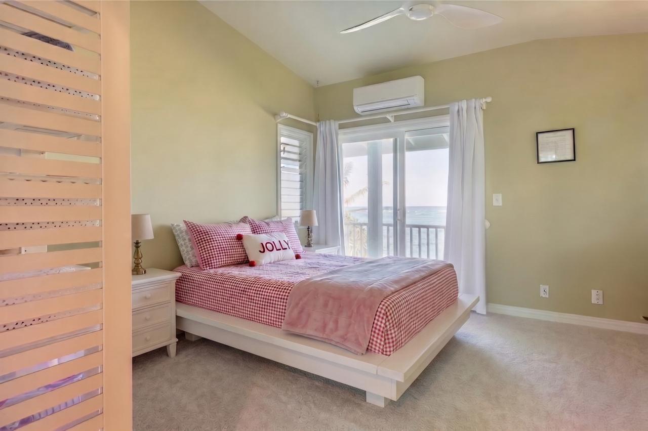 The Main House bedroom with pink bedding and balcony doors