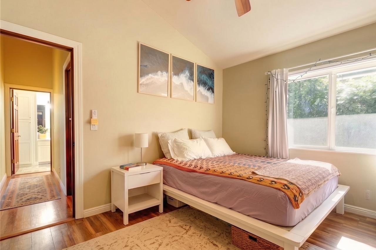 The Main House bedroom with large window and bathroom doorway