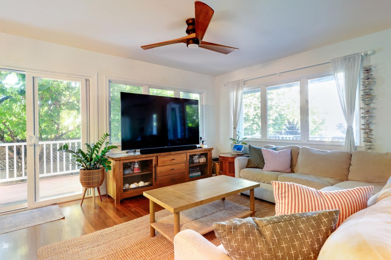 The Main House living room with large windows and TV