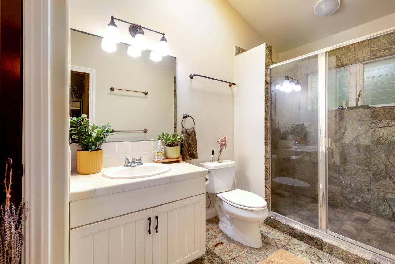 The Main House bathroom with vanity and glass shower