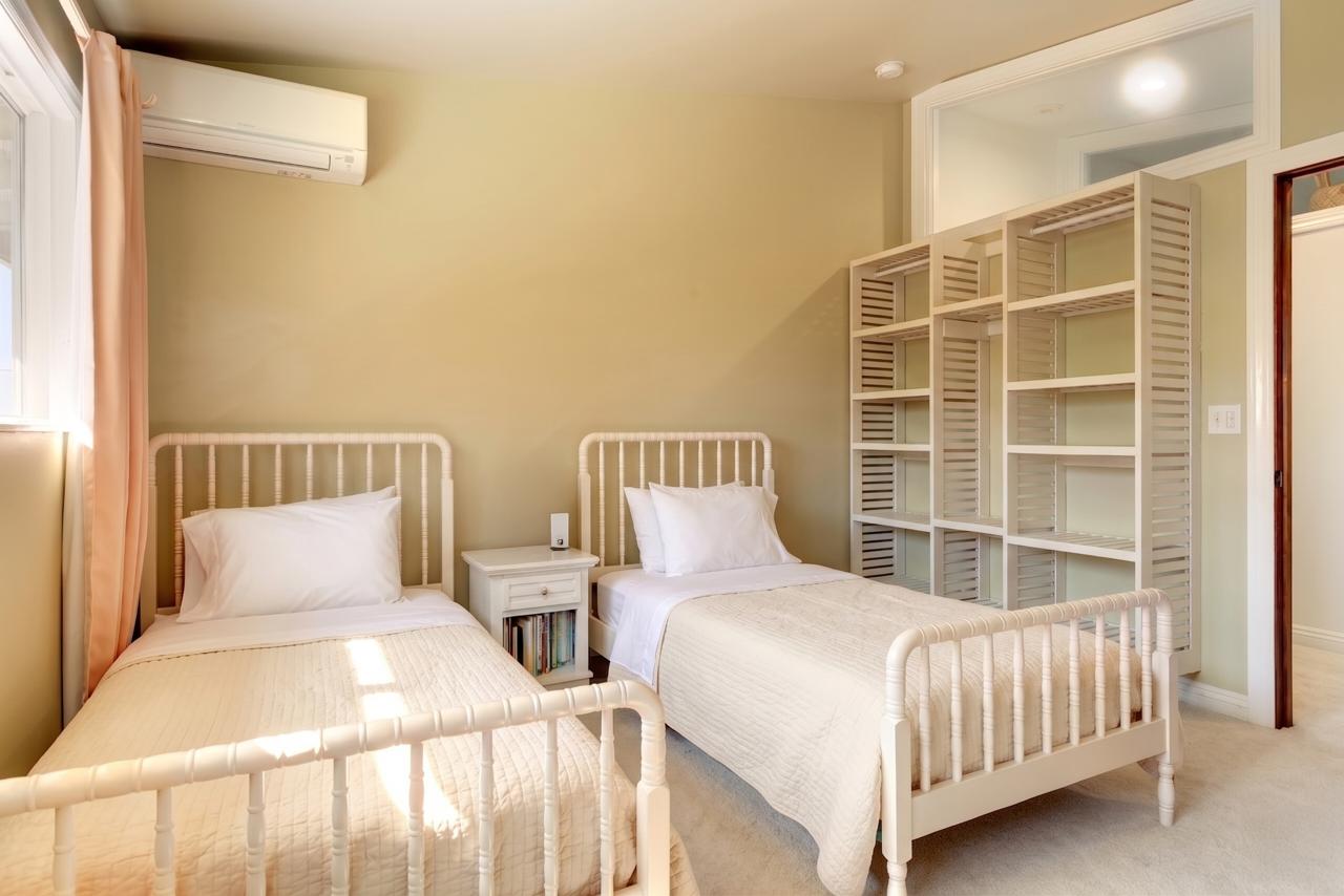 The Main House twin bedroom with two white beds